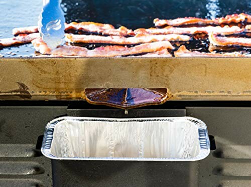 Bacon cooking on a griddle with a grease trap below.