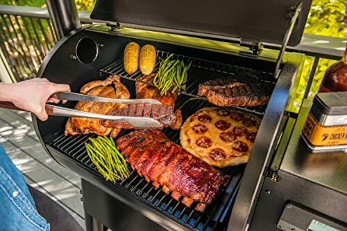 Grill with assorted foods including meat, corn, and vegetables.