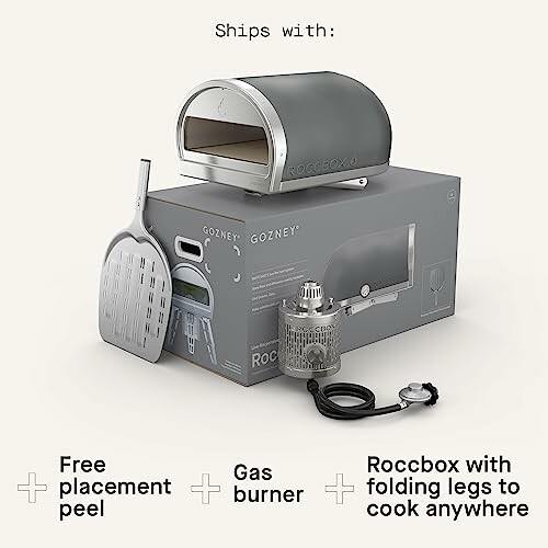 Portable pizza oven with accessories including peel, gas burner, and folding legs.