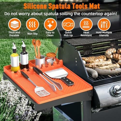 Silicone spatula tools mat next to a grill with utensils.