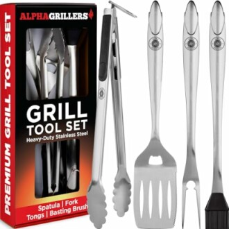 Stainless steel grill tool set with spatula, fork, and tongs next to packaging.